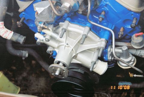 1980 Ford Mustang - Close-up view of an engine's water pump and associated plumbing.