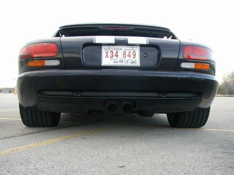 1996 Dodge Viper - Rear view of a black 1996 Dodge Viper, showing its distinctive taillights and dual exhaust pipes.