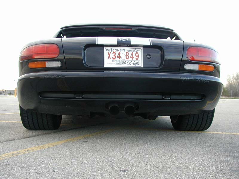 Rear view of black Dodge Viper roadster with white stripes, center-exit dual exhaust, Wisconsin temp plate