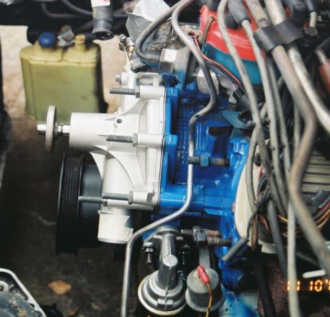 1980 Ford Mustang - The engine's water pump is visible, with blue paint on the block.