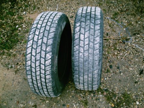 2001 Dodge 2500 - Two tires are shown on a gravel surface, with one tire appearing wider than the other.