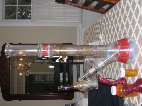 1996 Ford Crown Victoria - A glass smoking apparatus is shown on a table, with pill bottles nearby.