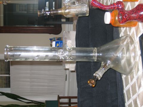 1996 Ford Crown Victoria - A glass bong with decorative red and clear accents is visible on a table, alongside other items.