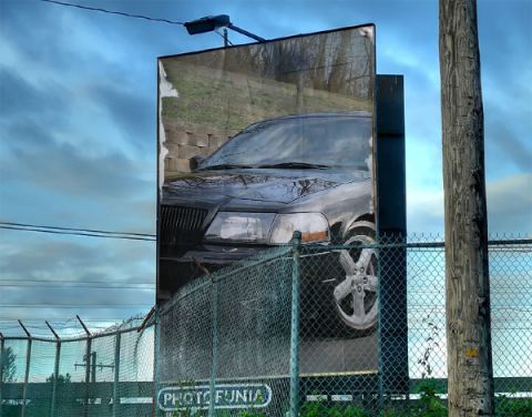 2003 Mercury Marauder - A billboard displays a car image, with a fence and text visible in the foreground.
