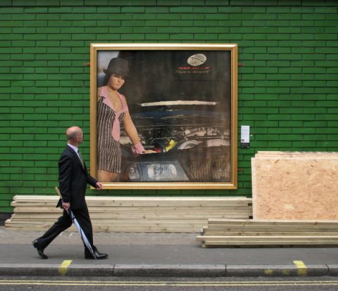 2003 Mercury Marauder - A large framed painting of a woman and a car engine is displayed on a brick wall.
