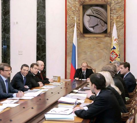 2003 Mercury Marauder - A meeting is taking place around a large wooden table, with several men in formal attire present.