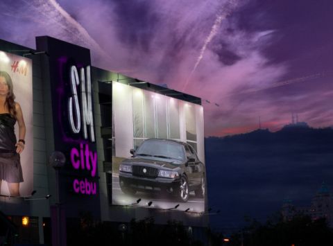 2003 Mercury Marauder - A billboard displays a black 2003 Mercury Marauder against a dramatic purple sky.