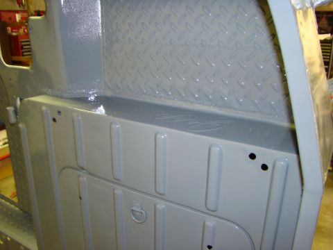 1948 Jeep Wrangler - The interior of a Jeep CJ shows freshly painted ribbed panels and a diamond plate rear wall.