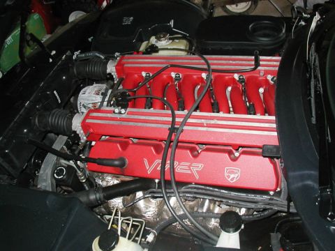 1996 Dodge Viper - Close-up of a red Viper engine, silver stripes and black hoses.
