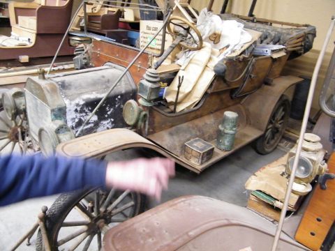 1909 Ford Model T - This 1909 Ford Model T is in a state of disrepair, with visible rust and a cluttered interior.