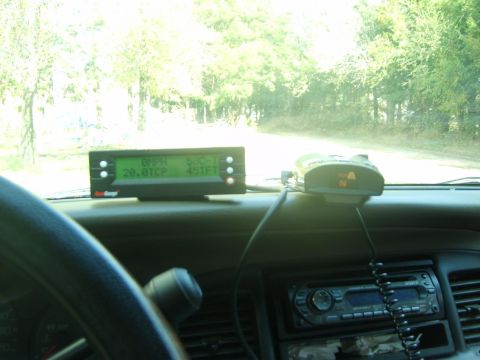 2000 Mercury Grand Marquis - The interior of a vehicle shows a digital display and a radar detector mounted on the dashboard.