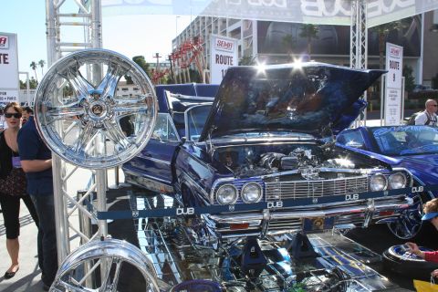 1998 Ford Crown Victoria - A customized lowrider is displayed with its hood open, chrome wheels and custom paint.
