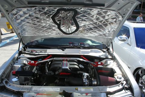 1998 Ford Crown Victoria - Customized engine bay with aftermarket parts and sound deadening material under the hood.