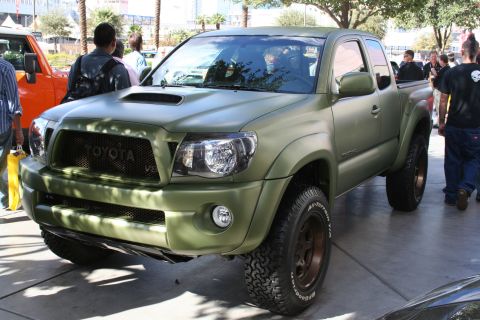 1998 Ford Crown Victoria - This matte green Toyota Tacoma pickup truck features off-road tires and a custom grille.