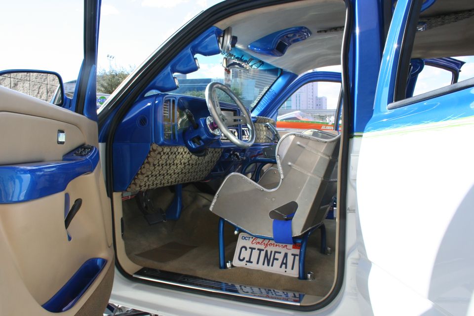 Interior of a truck with custom blue paint, racing seat, and a California license plate that reads CITNFAT