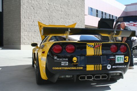 1998 Ford Crown Victoria - A race-prepped Corvette with 'CORVETTERACING.COM' visible on the rear.