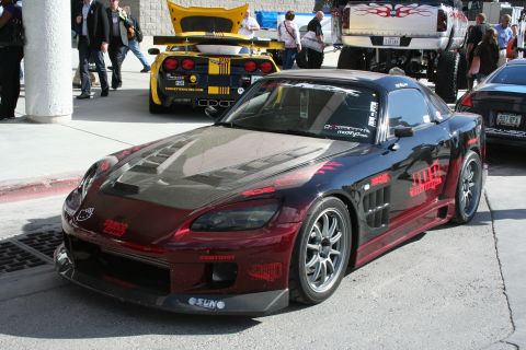 1998 Ford Crown Victoria - A heavily modified sports car with custom paint and bodywork is parked outdoors.