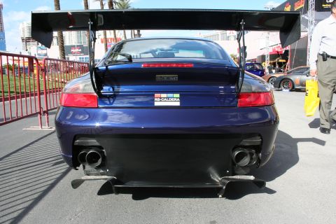 1998 Ford Crown Victoria - Rear view of a modified Porsche 911 with a prominent rear wing and custom badging.