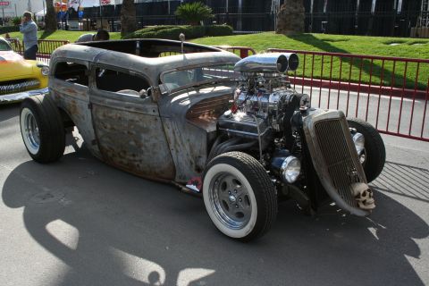 1998 Ford Crown Victoria - Custom rat rod with a prominent supercharged engine and a skull ornament on the front grille.