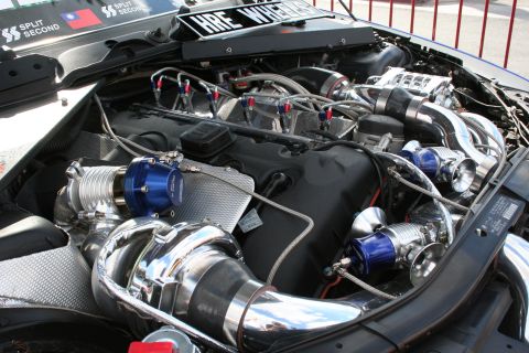 1998 Ford Crown Victoria - Modified engine bay with prominent turbochargers and intercooler piping.