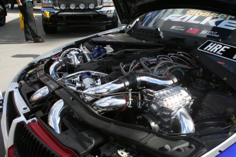 1998 Ford Crown Victoria - Customized engine bay twin turbochargers and polished components, with an HRE logo on the side.