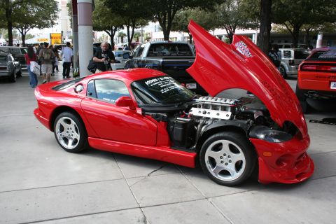 1998 Ford Crown Victoria - Red Dodge Viper on display with its hood open, showing the engine bay.