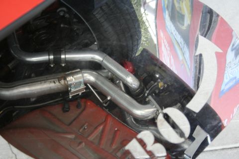 1998 Ford Crown Victoria - A close-up view of a vehicle's custom exhaust system, highlighting the polished metal pipes and clamps.