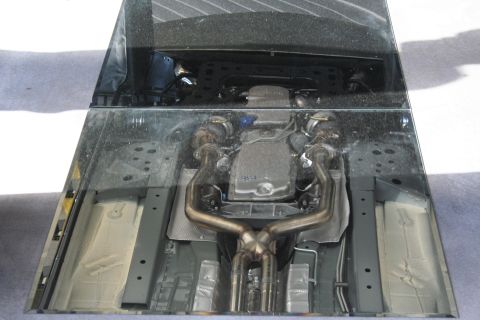 1998 Ford Crown Victoria - The underside of a vehicle is shown, revealing the engine and exhaust components.