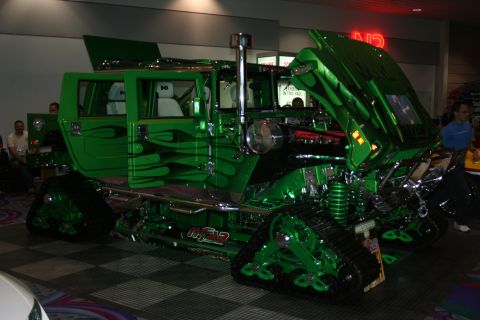 1998 Ford Crown Victoria - This heavily modified vehicle features custom green paint with flame graphics and track-based locomotion.