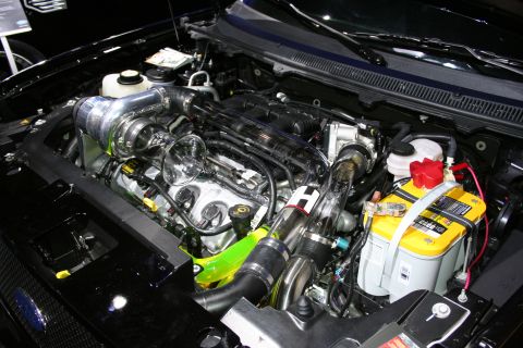1998 Ford Crown Victoria - Customized engine bay a prominent turbocharger and vibrant green intercooler piping.
