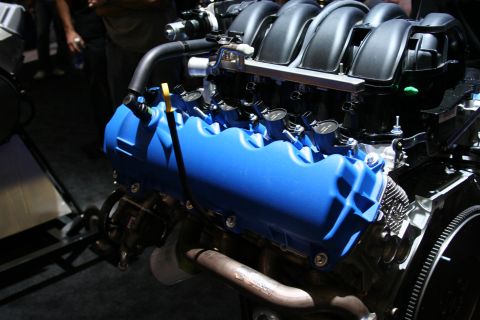 1998 Ford Crown Victoria - Close-up view of a blue engine with black intake and exhaust components.