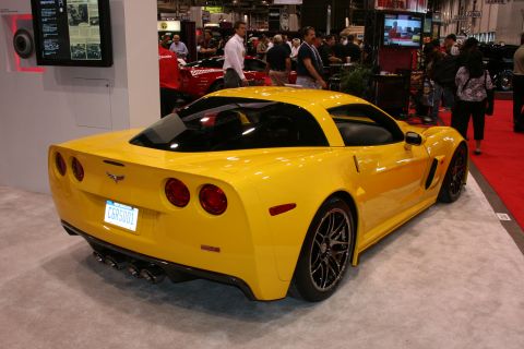 1998 Ford Crown Victoria - Rear view of a yellow Chevrolet Corvette C6 at an auto show.