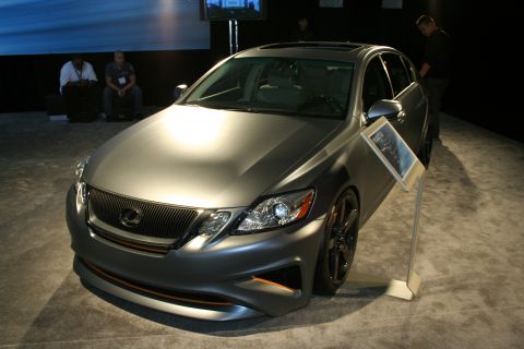 1998 Ford Crown Victoria - A matte gray Lexus GS sedan is displayed indoors, with a sign providing information about the vehicle.