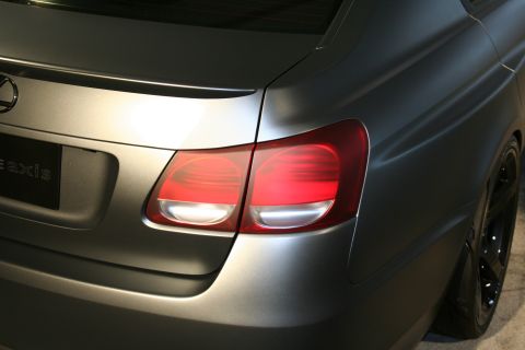 1998 Ford Crown Victoria - Close-up of the rear of a matte gray Lexus GS 350, showing the taillight and spoiler.