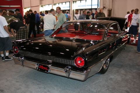 1998 Ford Crown Victoria - A black 1959 Ford Fairlane convertible is displayed with its red interior and chrome accents visible from the rear.