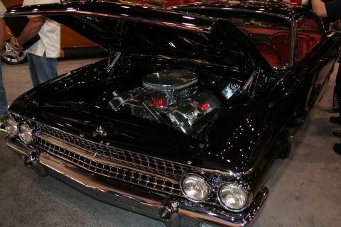 1998 Ford Crown Victoria - This black 1959 Ford Fairlane 500 Skyliner features a polished chrome engine under its open hood.