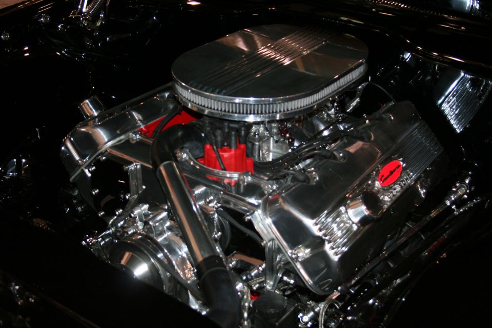 Close-up of a polished chrome V8 engine, showing air cleaner, distributor, and valve covers