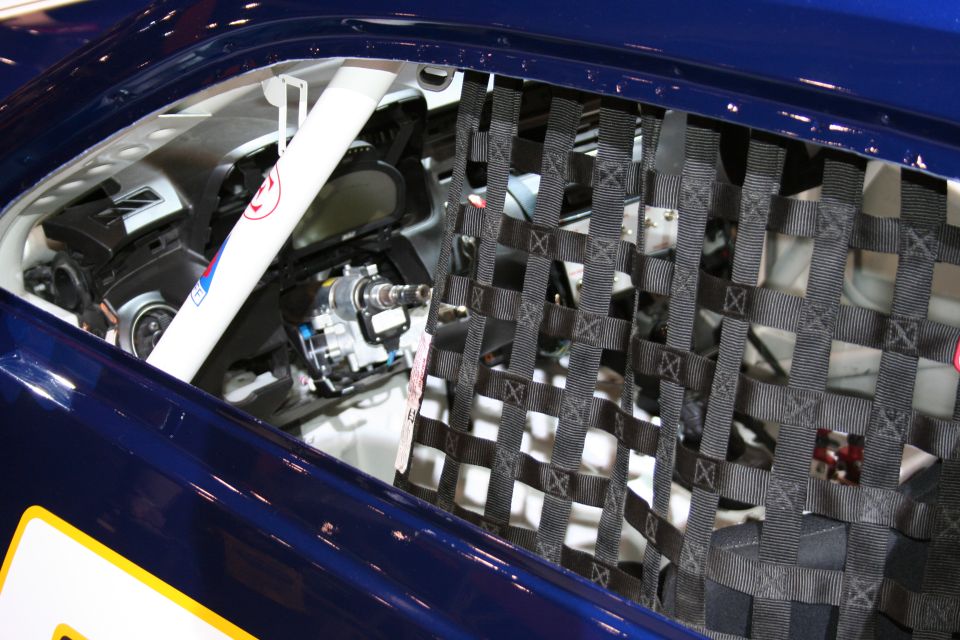 Race car interior with safety net and steering column visible