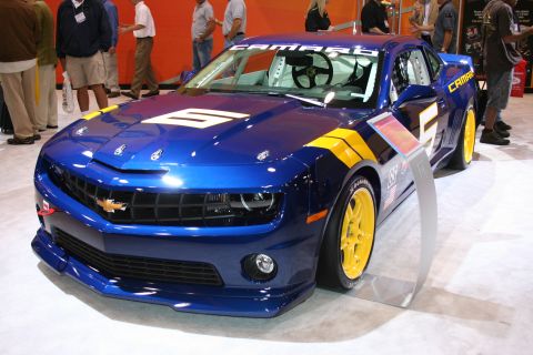 1998 Ford Crown Victoria - This Chevrolet Camaro race car features a blue paint scheme with yellow racing stripes and the number 6.