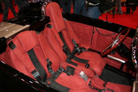 1998 Ford Crown Victoria - Interior view of a custom hot rod, red suede seats and a wooden steering wheel.