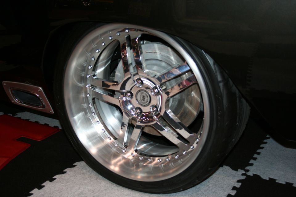 Custom chrome wheel and tire on a black car