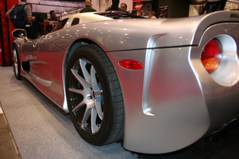 1998 Ford Crown Victoria - A rear three-quarter view of a silver sports car with a unique taillight design and custom wheels.