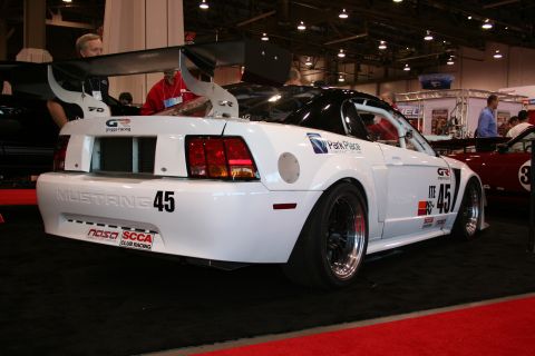 1998 Ford Crown Victoria - This white Ford Mustang race car features a prominent rear spoiler and racing decals, including the number 45.