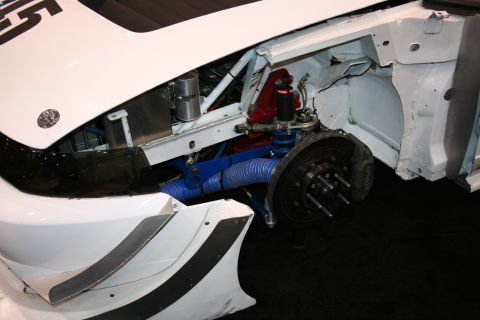 1998 Ford Crown Victoria - The front wheel assembly and suspension components of a modified vehicle are visible.