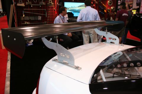 1998 Ford Crown Victoria - A white race car is equipped with a large black spoiler and a visible roll cage.