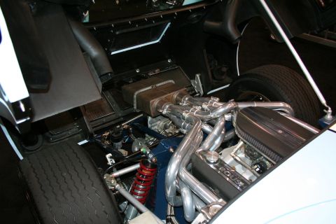 1998 Ford Crown Victoria - Close-up view of a modified engine bay, showing custom exhaust and suspension components.