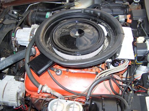 1991 Ford LTD Crown Victoria - Close-up view of an engine bay, showing the V8 engine block, air filter, and various hoses and wires.