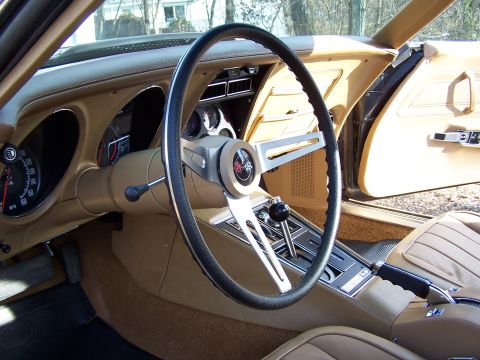 1991 Ford LTD Crown Victoria - The interior of a vintage car, a tan dashboard, steering wheel, and seats.