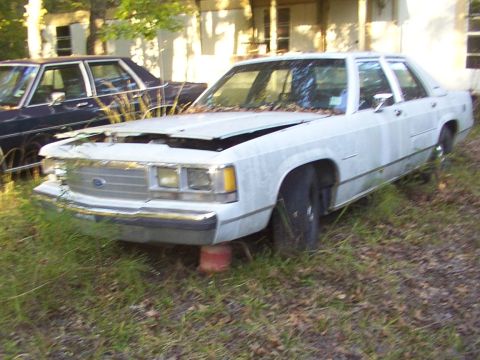 1991 Ford LTD Crown Victoria - This 1991 Ford Crown Victoria LTD is parked in a grassy area with another vehicle behind it.
