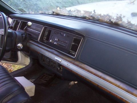 1991 Ford LTD Crown Victoria - Interior view of a car's dashboard, showing the center console and steering wheel area.